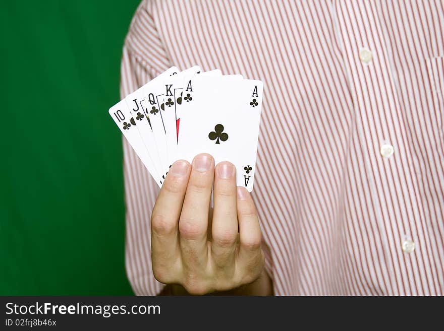 A young man in a red striped shirt, holding Royal flush