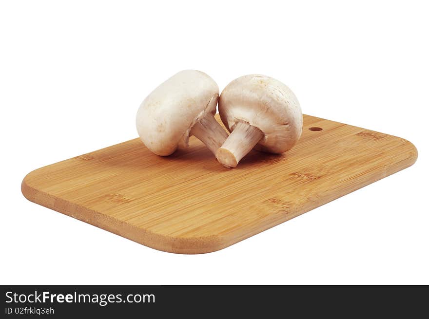 Mushrooms on a wooden board isolated on white. Mushrooms on a wooden board isolated on white