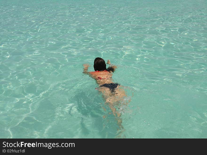 Girl swimming in saona beach