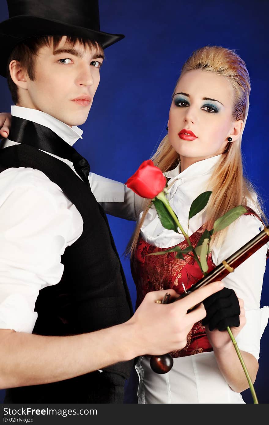 Portrait of the elegant young couple in medieval era costumes. Shot in a studio. Portrait of the elegant young couple in medieval era costumes. Shot in a studio.