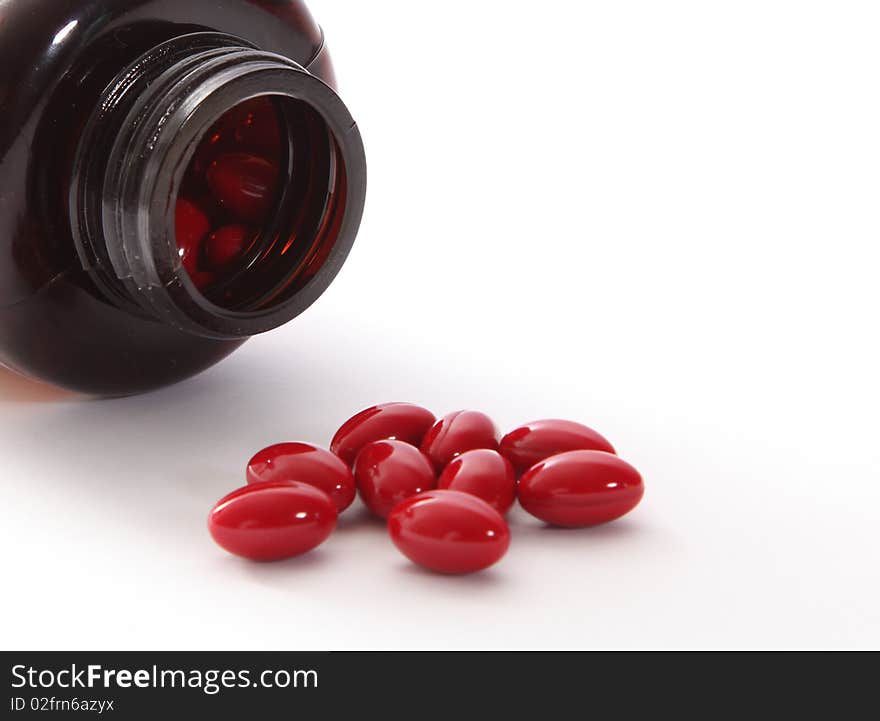 Packaging red capsules on white background. health image