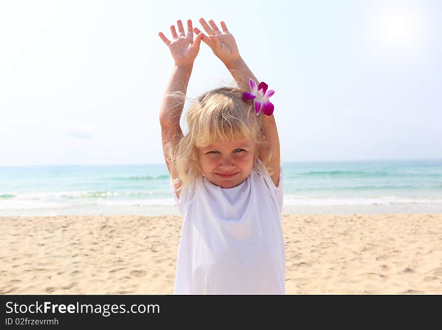 Beautiful little girl on the beach with orchid. Beautiful little girl on the beach with orchid