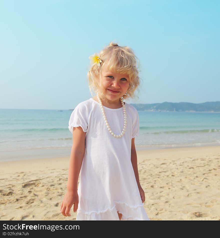 Beautiful little girl with white curly hair of the sea. Beautiful little girl with white curly hair of the sea