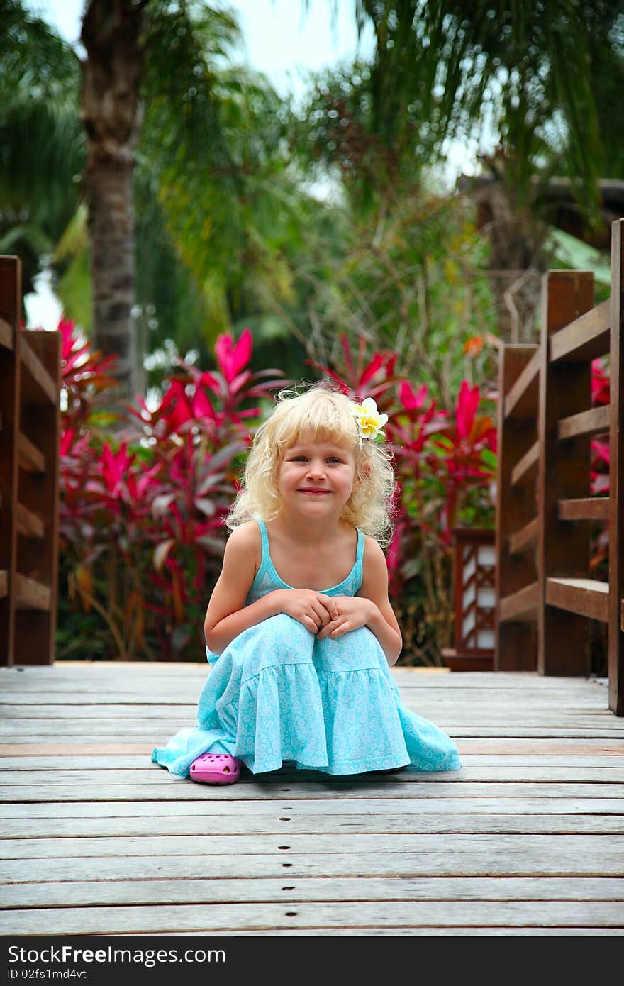 Portrait of a beautiful little girl with plumeria