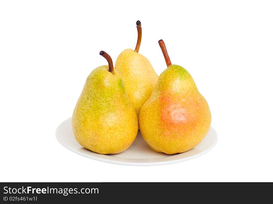 Three pears lie on a plate isolated on a white background.