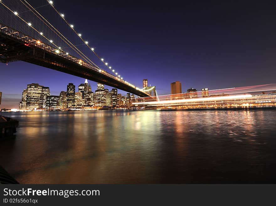 Downtown Manharttan photographed after sunset with a cruise boat passing in the foreground. Downtown Manharttan photographed after sunset with a cruise boat passing in the foreground