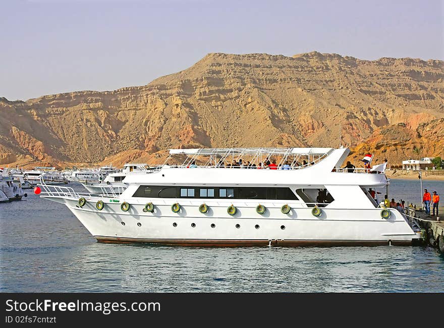 Most beautiful yacht stands near the shore at the pier.