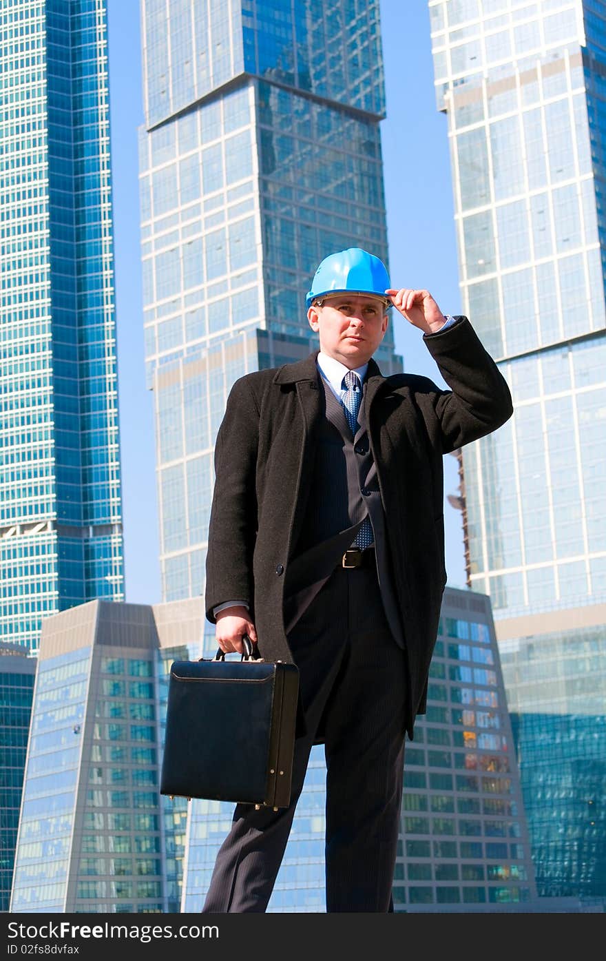 Engineer with blue hard hat holding briefcase