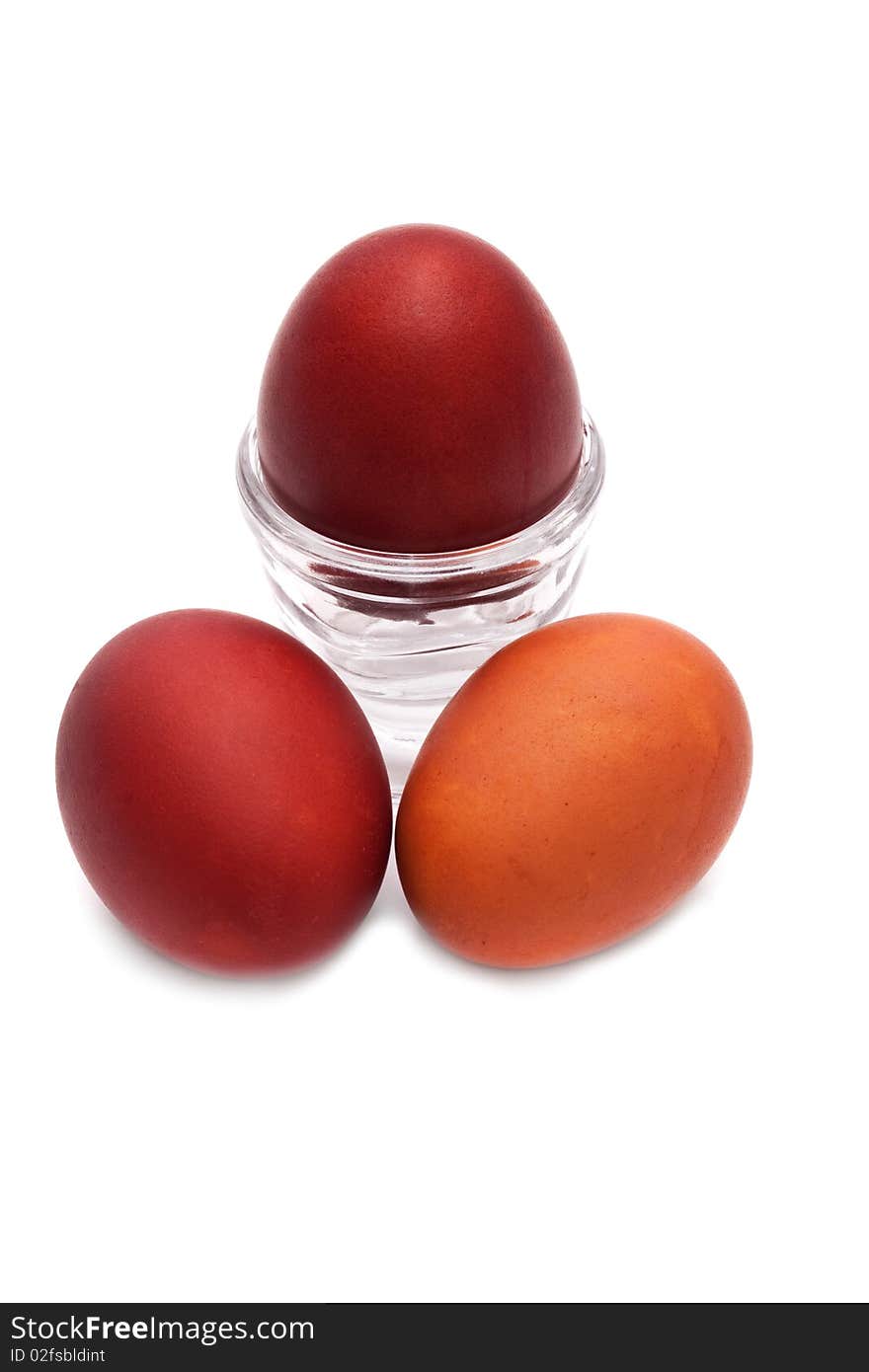 Red Easter egg in a glass stand on a white background