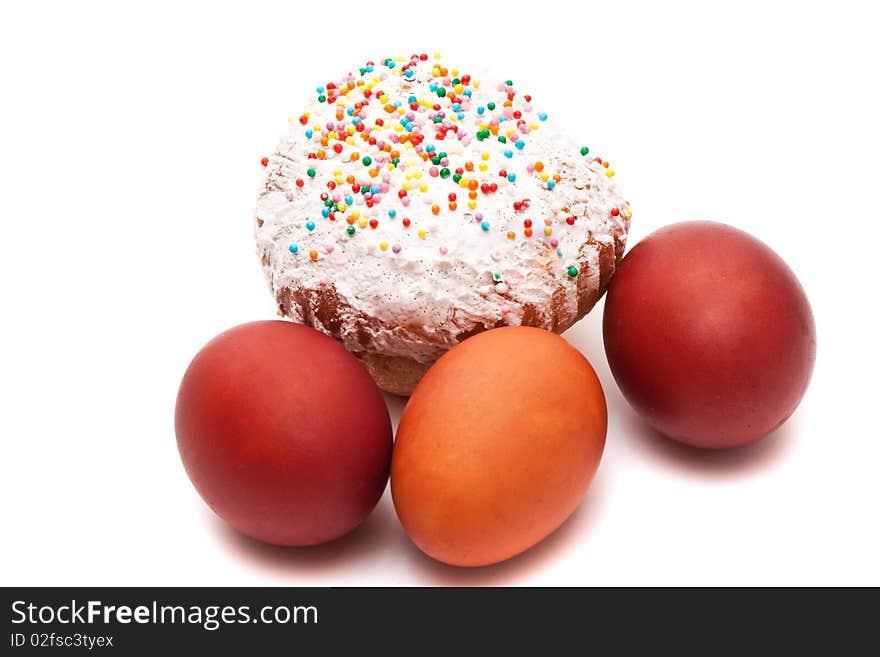 Red Easter eggs and Easter bread on a white background