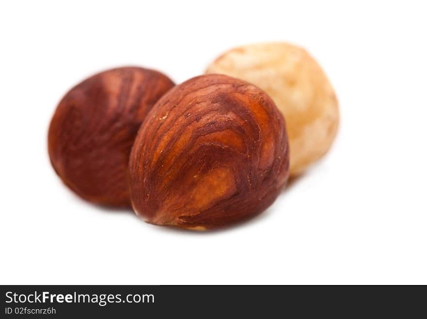 Purified hazelnuts on a white background close