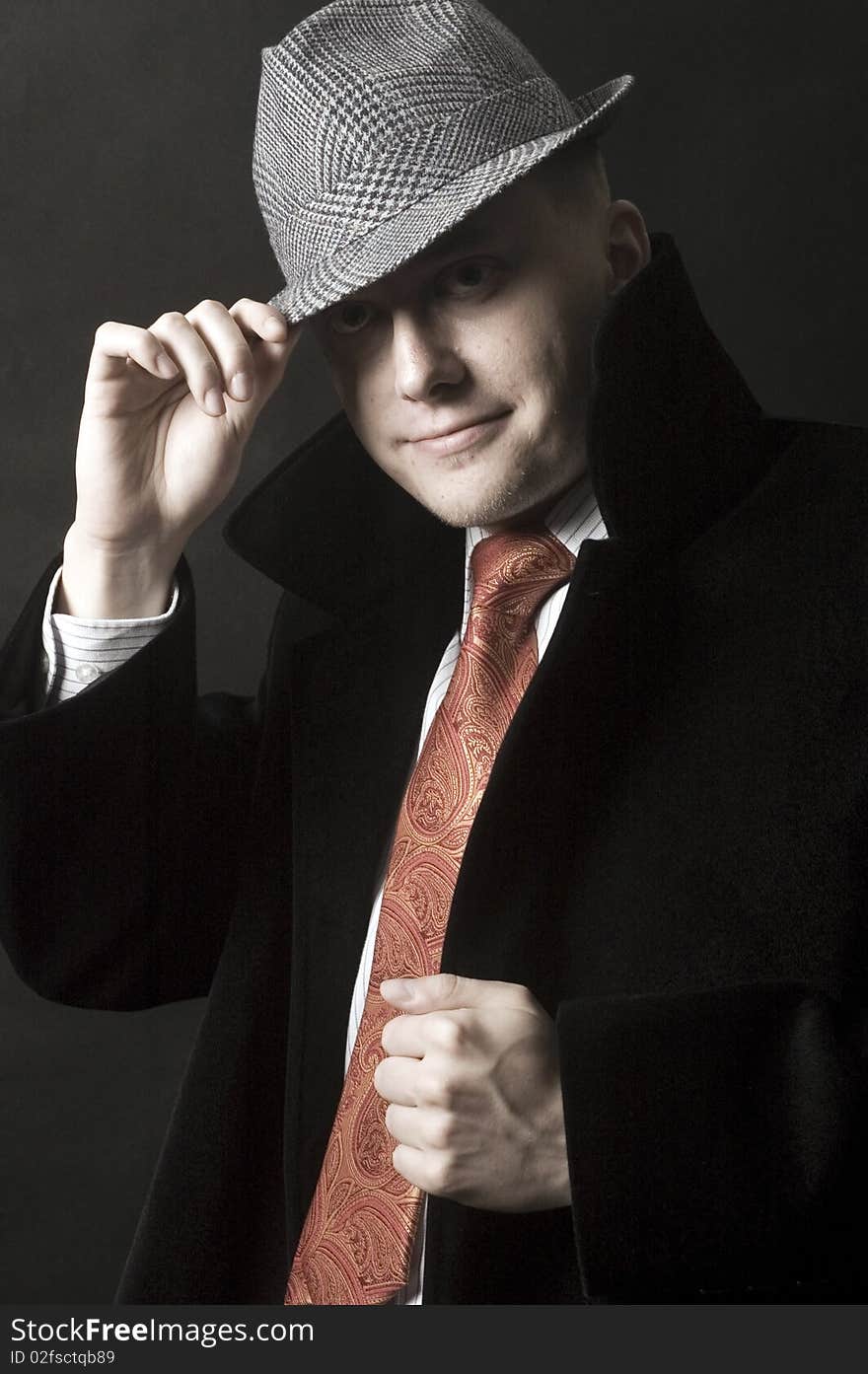 Young European gentleman with elegant clothes, tie and coat, wearing stylish hat. Young European gentleman with elegant clothes, tie and coat, wearing stylish hat.