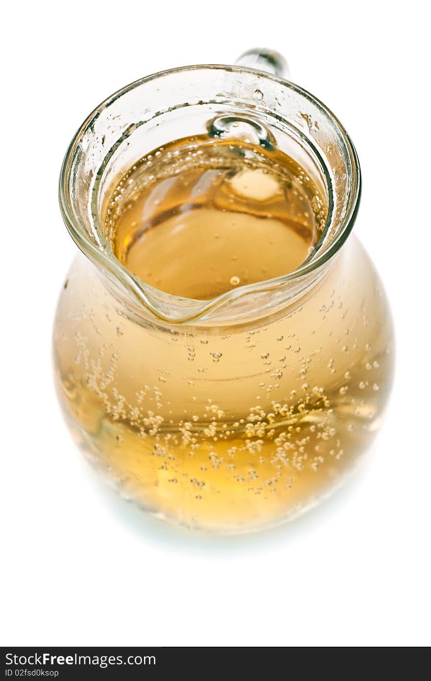 Glass pitcher of lemonade on a white background