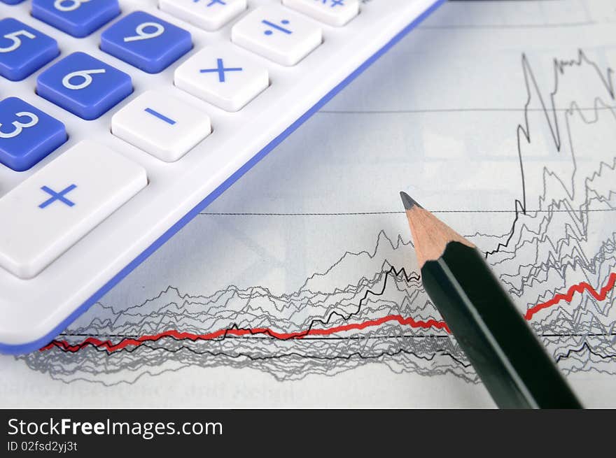 A graph sheet, with a pencil and a calculator, means status, statistic, working and calculating. A graph sheet, with a pencil and a calculator, means status, statistic, working and calculating.