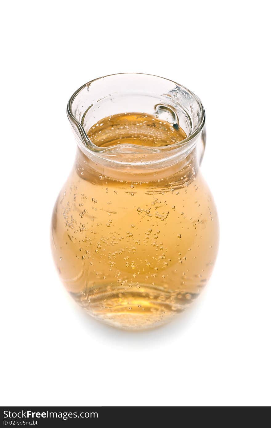 Glass pitcher of lemonade on a white background