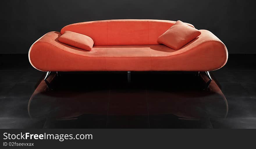 Red sofa against the black background