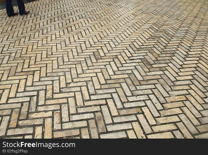 Pedestrian Walking Along A Wet Road.