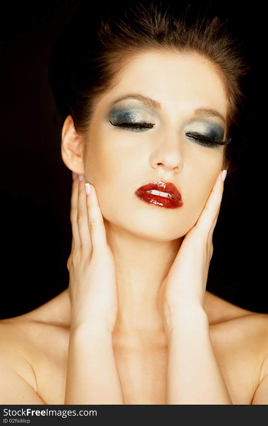 Portrait of a beautiful brunette woman isolated  on black