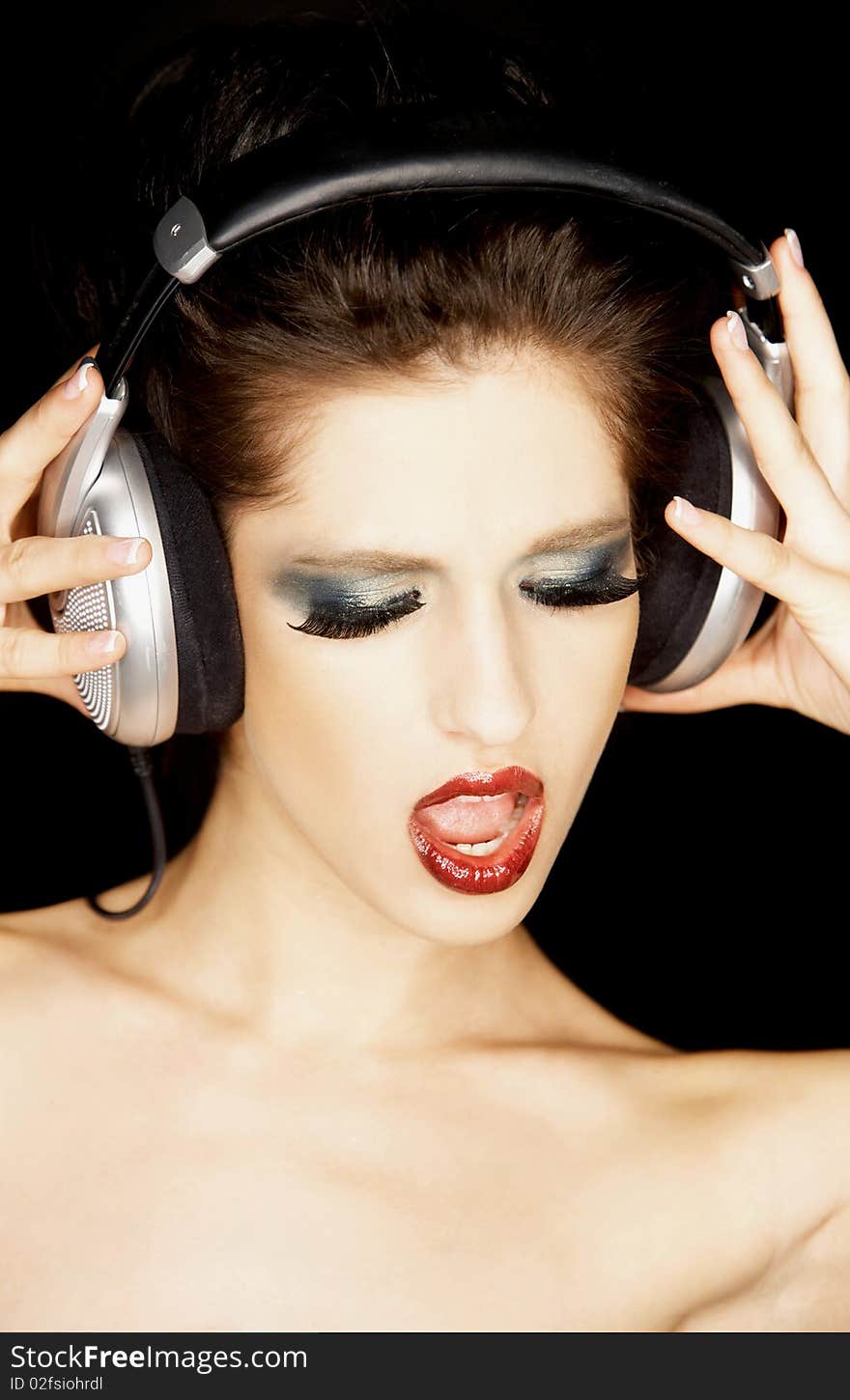 Portrait of a beautiful brunette woman with a headphones