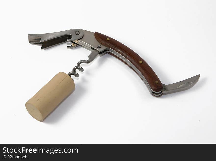 Corkscrew with cork on white background