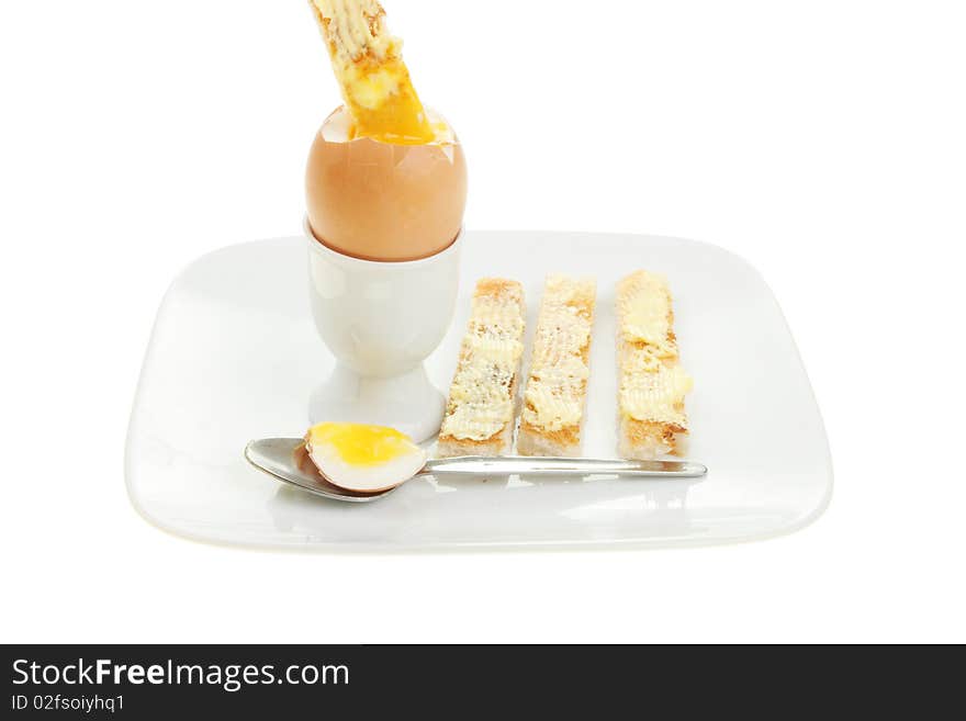 Boiled egg and toast soldiers on a plate isolated against white. Boiled egg and toast soldiers on a plate isolated against white