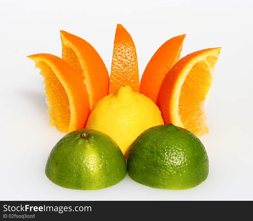 A lemon sunset, with a lemon representing the sun, orange segments as the rays and two cut lime halves as the mountains in the foreground.