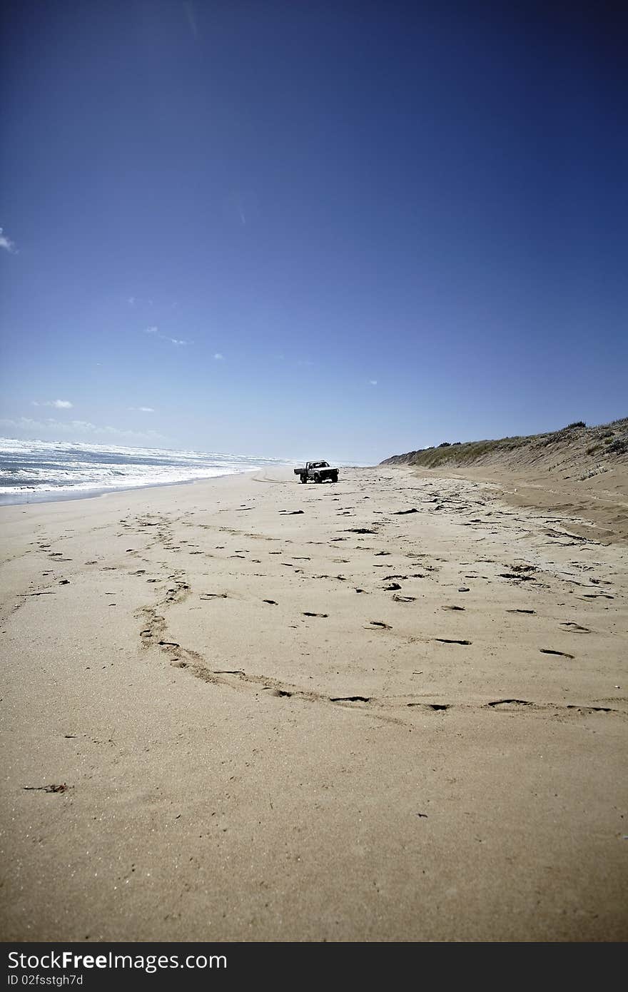 Truck driving on the long and empty beach. Truck driving on the long and empty beach