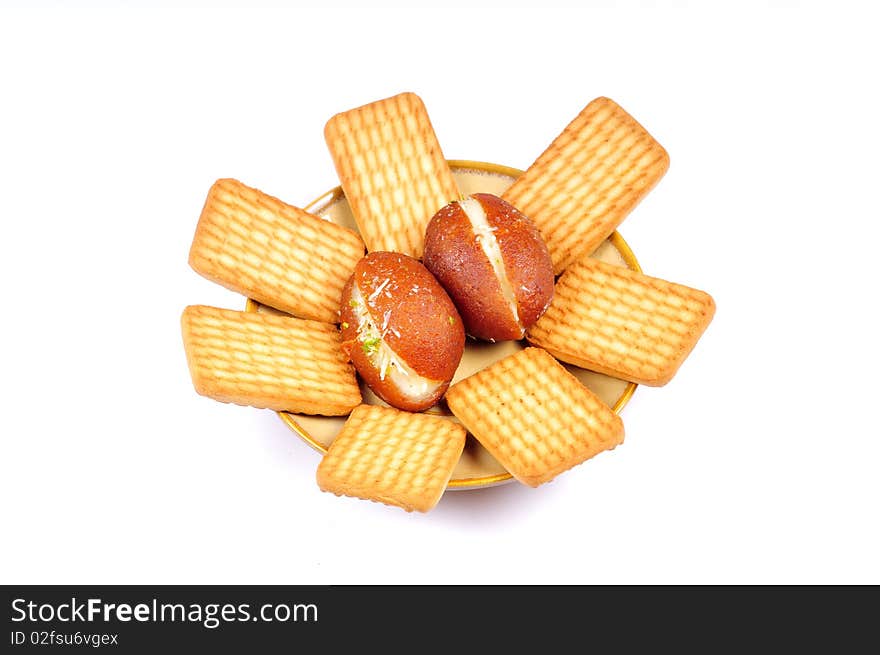 Gulucose biscuits and gulab jamuns isolated on white background. Gulucose biscuits and gulab jamuns isolated on white background.