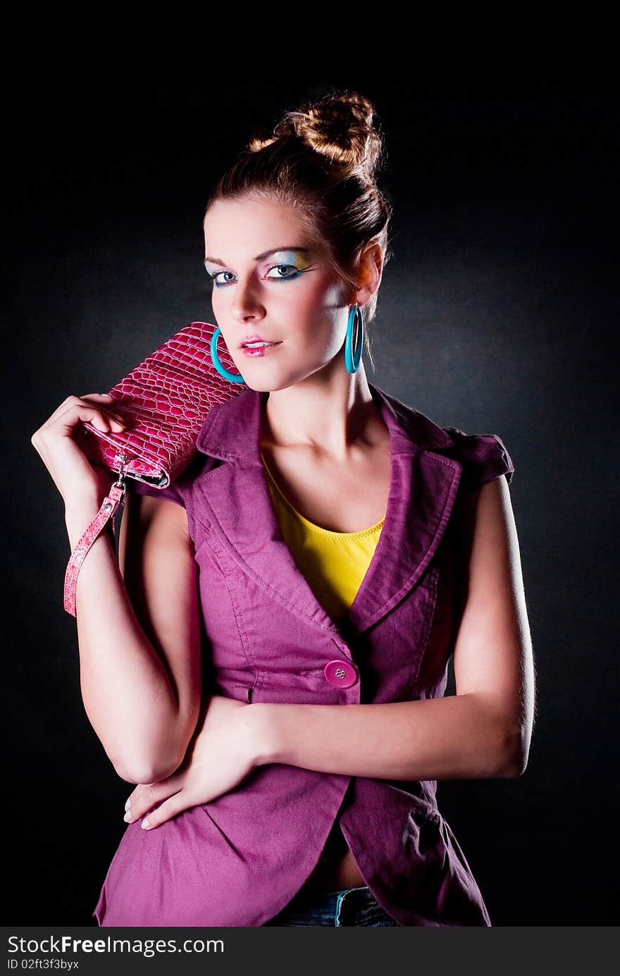 Fashion photo, model with a bag posing on light background. Fashion photo, model with a bag posing on light background