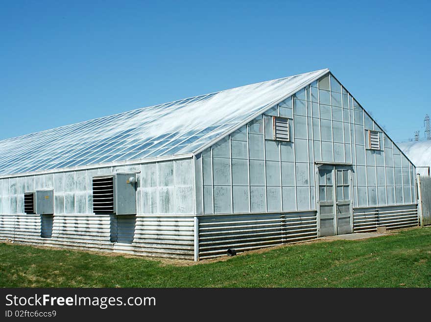 A green house with blue sky. A green house with blue sky