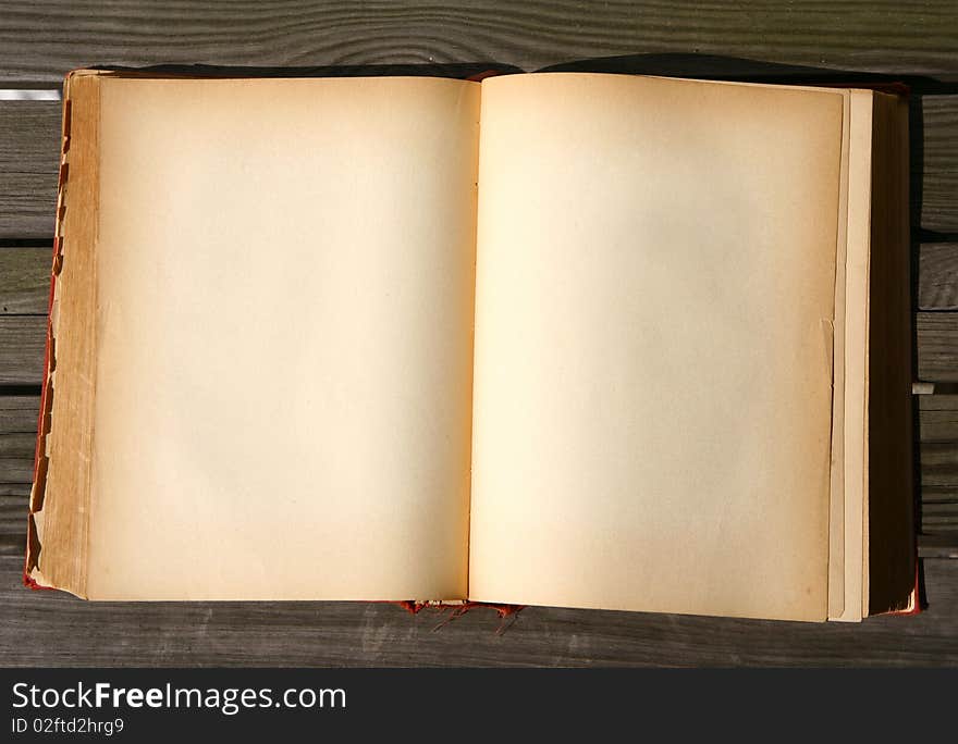 Old book with blank pages on wooden background