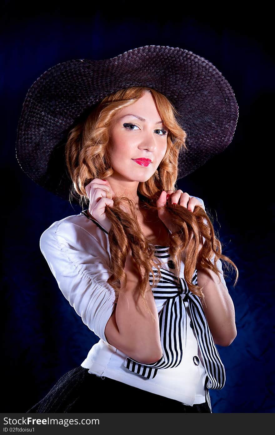 Photo-session of the young beautiful  woman with black hat