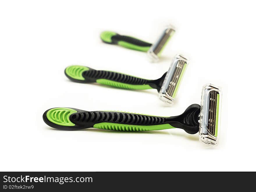 Three black and green razors. Three black and green razors