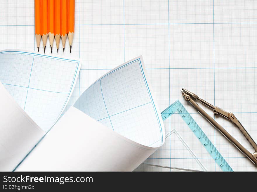 Divider, pencils and ruler on blue graph paper background. Divider, pencils and ruler on blue graph paper background