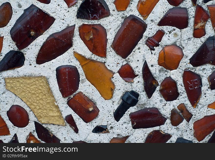 Multicolored glass embedded in artsy wall. Multicolored glass embedded in artsy wall