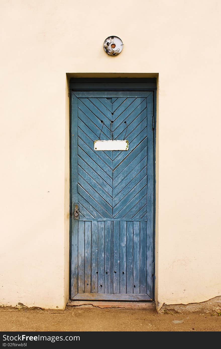 Blue vintage door with empty white doorplate