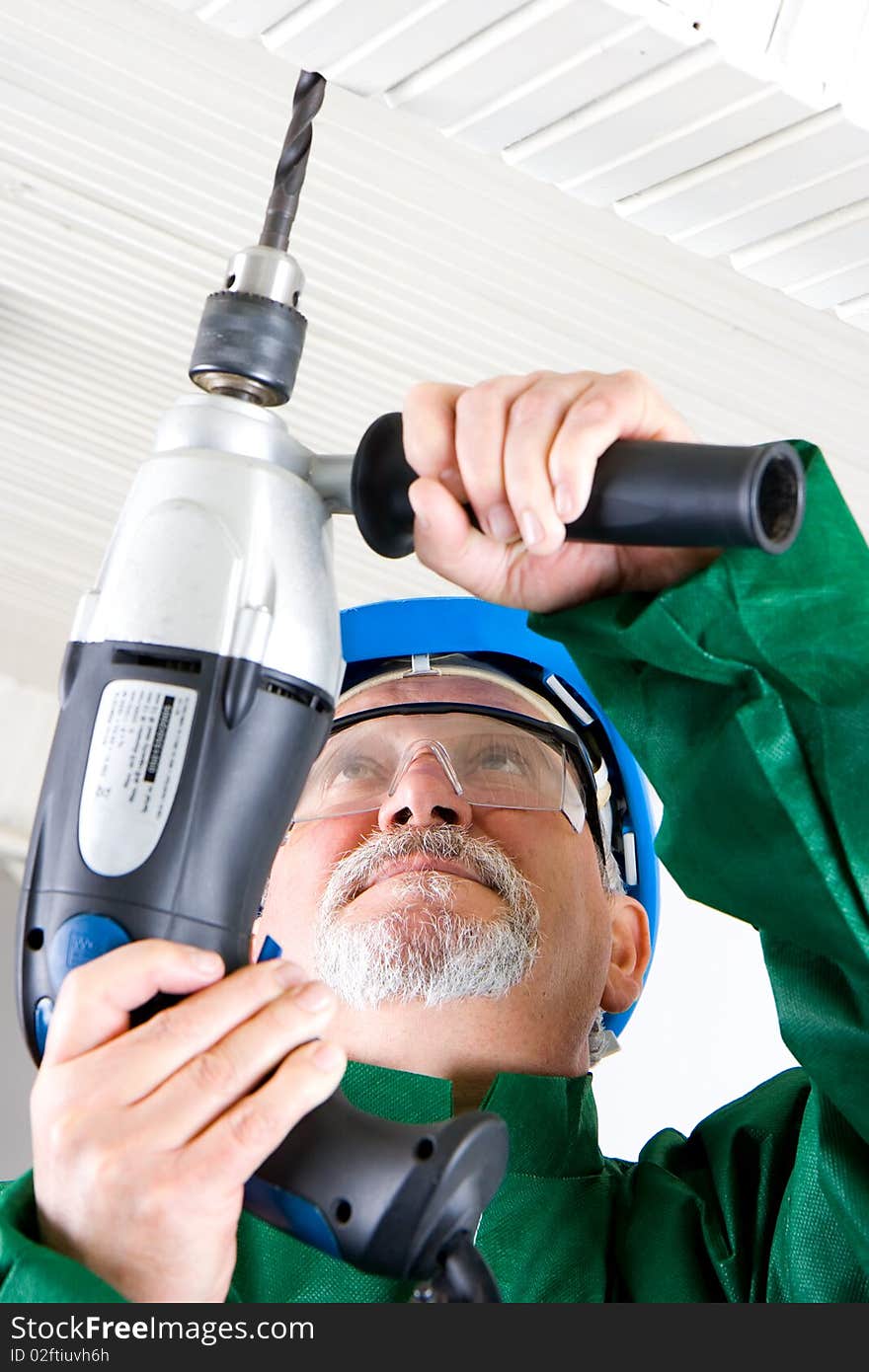 Construction worker holding the electric hand drill. Construction worker holding the electric hand drill