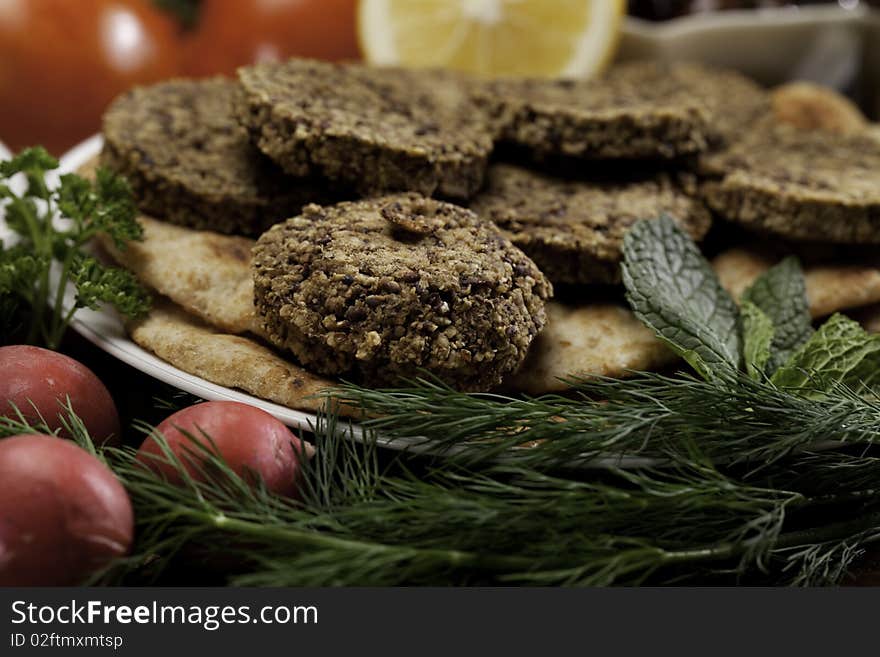 Mediterranean meal of falafels with humus, olives, chickpeas, radishes and tomatoes. Mediterranean meal of falafels with humus, olives, chickpeas, radishes and tomatoes.