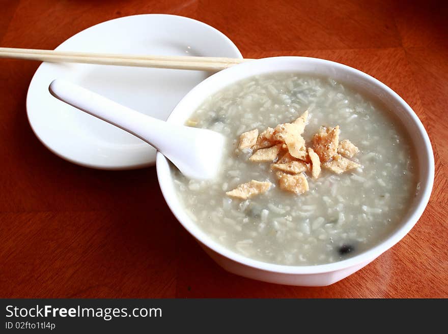 A bowl of chinese conjee on the table.Usually eat it at breakfast time. A bowl of chinese conjee on the table.Usually eat it at breakfast time.