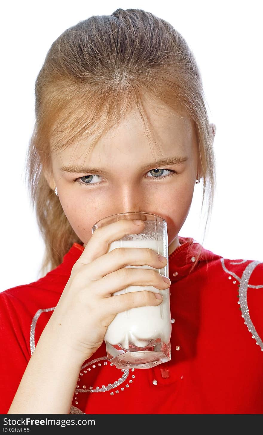 Little girl drinks milk from glass isolated on white