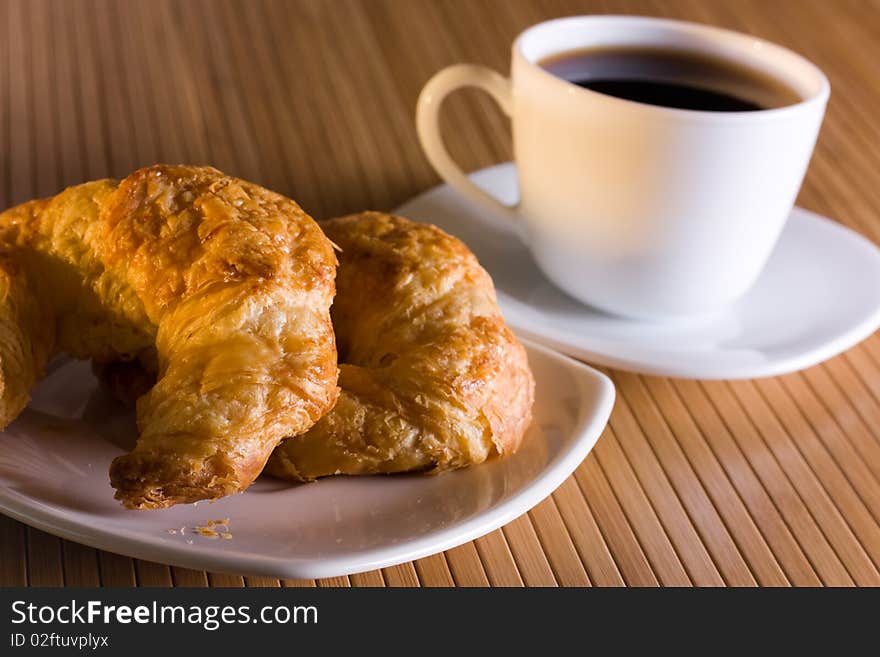 Breakfast with  coffee and croissants.