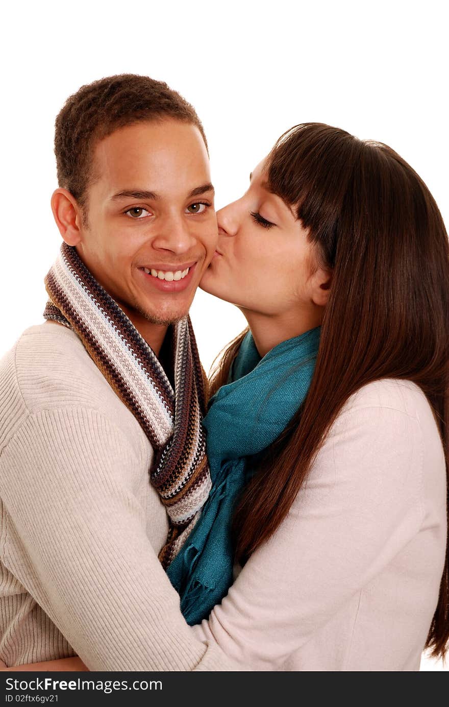 Teenage girl giving happy boy a kiss on cheek. Teenage girl giving happy boy a kiss on cheek