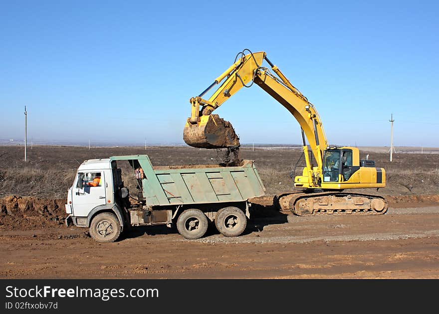 Dredge loads a ground in the truck. Dredge loads a ground in the truck