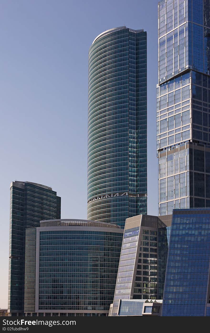 Blue modern office buildings over blue sky