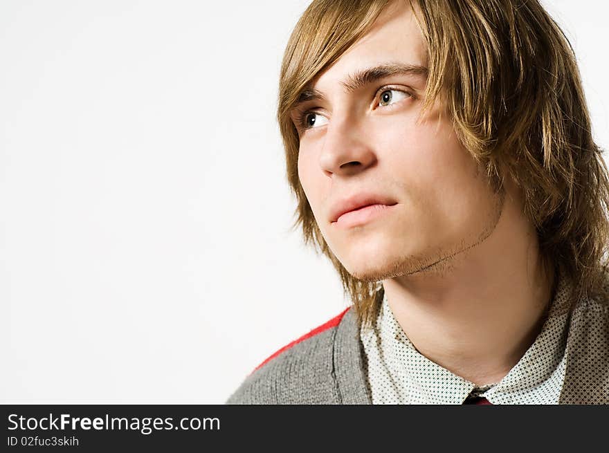 Close-up portrait of young man on light grey background