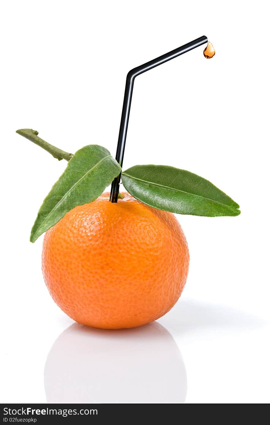 Tangerine with green leaves and straw