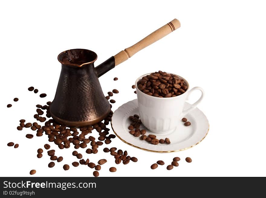 Coffee pot and cup with beans staying on the beans on white background. Coffee pot and cup with beans staying on the beans on white background