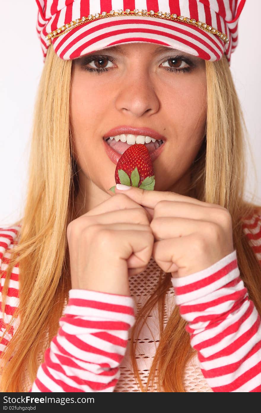 Beautiful woman eating strawberry