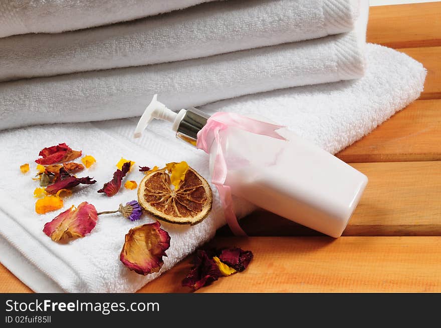 White towels with dry flowers on bench. White towels with dry flowers on bench.