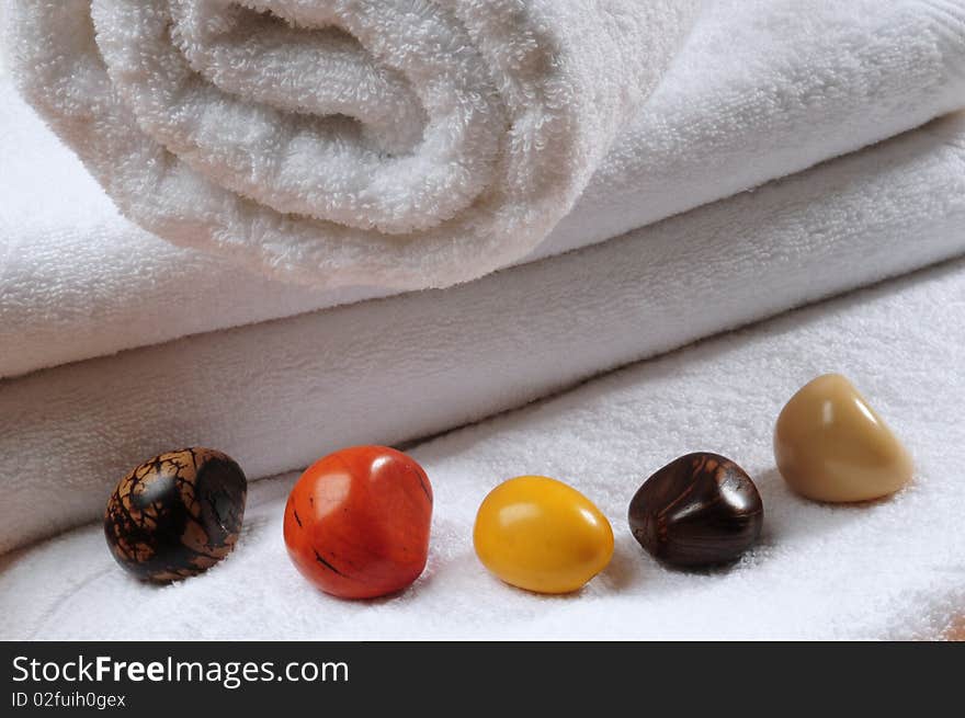 White towels with colorful stones. White towels with colorful stones.